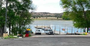 View of Lake and Lakeside Dock with Tourists Enjoying Scenery