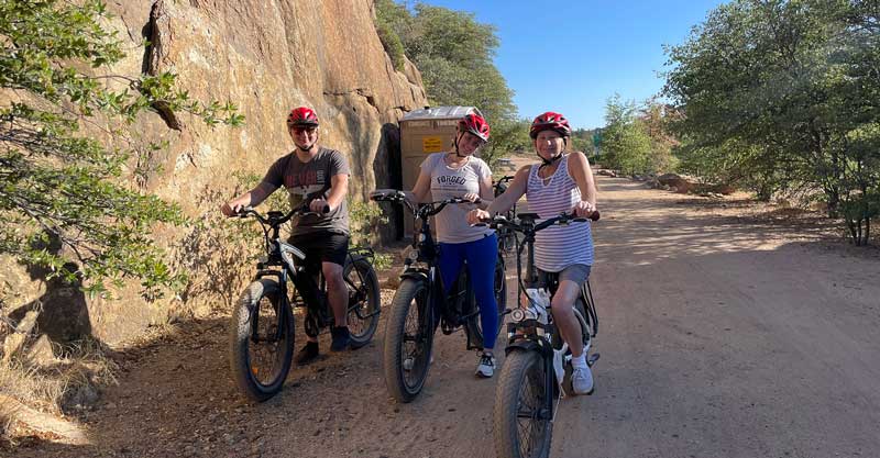 Family Members Posing for Photo with Ebikes on Trail