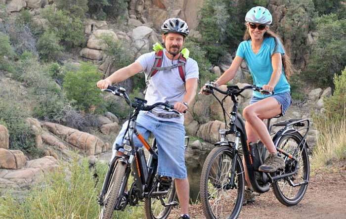 Couple Posing for Photo on Ebikes on Trail