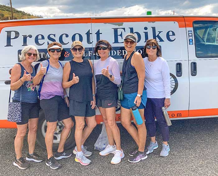 Group of Women Posing for Pictures in Front of Ebike Transport Van